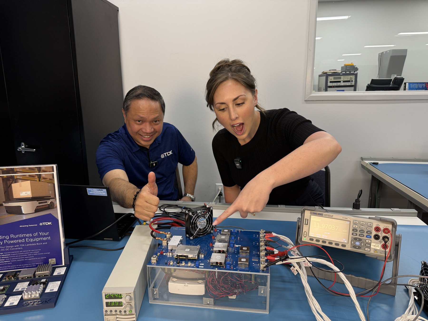 Jordan Yates and a technical expert demonstrating a power electronics test setup
